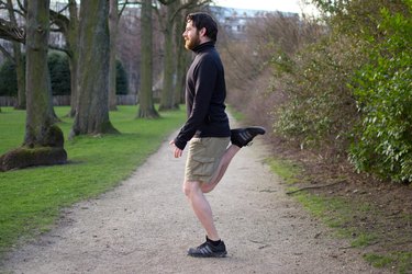 Man performing butt kicks before a bike ride
