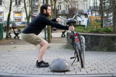 Man performing active squat before a bike ride