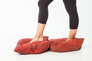 Woman demonstrating walking on pillows.