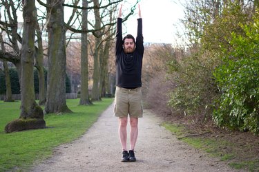 Man performing shoulder reach before a bike ride