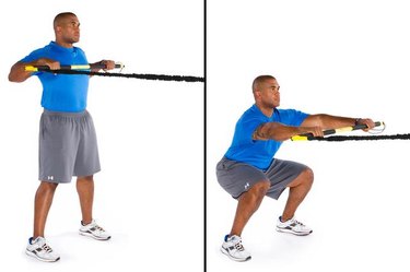 Man performing rip squat row TRX exercise