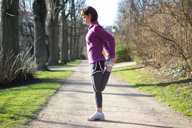 Woman doing Standing Quad Stretches before running