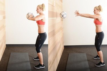 Woman performing ball chest press ab exercise.