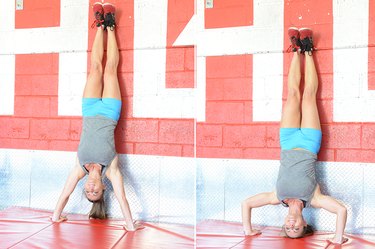 Woman performing handstand push-up.
