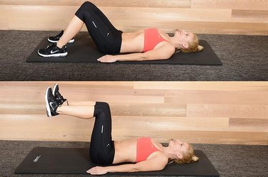 Woman performing leg raise ab exercise.