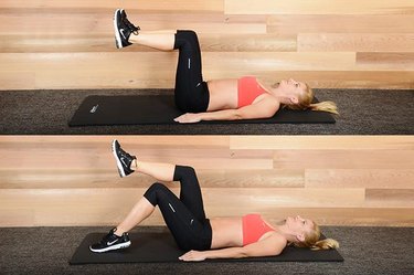 Woman performing toe tap exercise ab exercise.