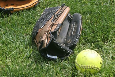 softball and mitt on grass