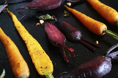 baked carrots and beets on  baking sheet