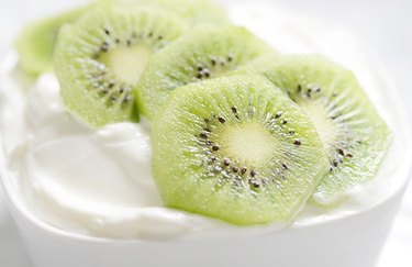 Kiwi slices over a bowl of yogurt.
