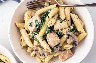 Diced chicken florentine with penne pasta, mushrooms, and spinach in an instant pot