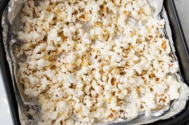 an overhead photo of popcorn in an air fryer as an example of a healthy late night snack