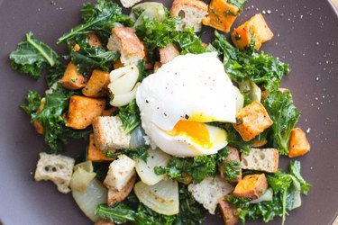 Winter panzanella breakfast salad with sweet potatoes  on a gray plate.