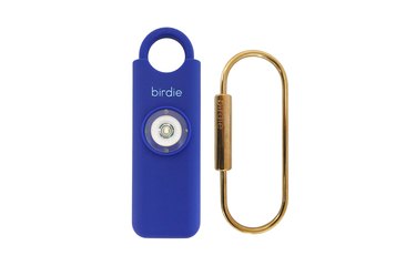 An image of a dark blue personal alarm device.