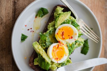 Avocado toast topped with a perfectly cooked soft-boiled egg