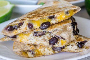 Turkey, bean and cheese quesadille on a white plate