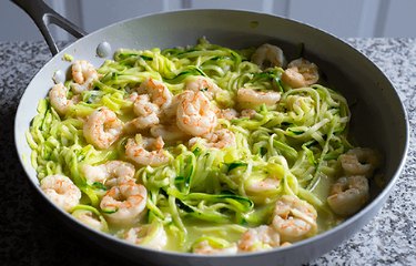 Lemon Garlic Shrimp and Zucchini Noodles in black bowl on marble table