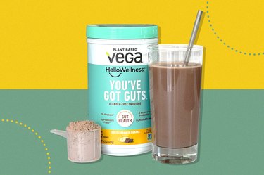 Vega 'You've Got Guts' Protein Smoothie Powder and glass of protein smoothie over yellow and green background