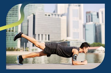 Person with short dark hair doing a forearm plank with leg lift in front of a downtown cityscape for the plank challenge
