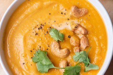 Bowl sweet potato soup with cashews and  coriander.