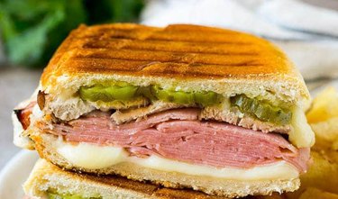 a Cuban Sandwich with ham, pork tenderloin and pickles on grilled bread