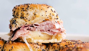 a Ham and Cheese Slider on a bun with poppy seeds