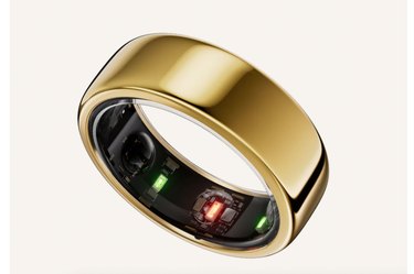 the Oura, one of the best fitness trackers, in a round gold style