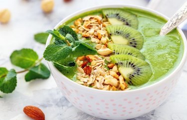 Avocado Smoothie Bowl With Almonds and Mint in white bowl