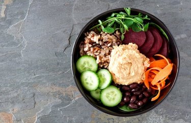 Beet and Carrot Buddha Bowl With Savory Dressing on gray background