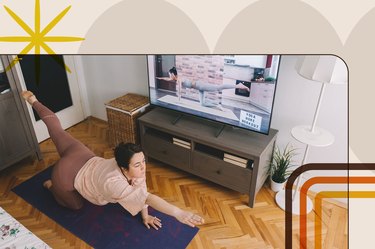 person wearing a light pink t-shirt and mauve leggings does a bird dog exercise on a blue yoga mat at home in front of a flatscreen TV showing a quick workout video