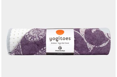 rolled-up purple yogitoes Manduka yoga towel