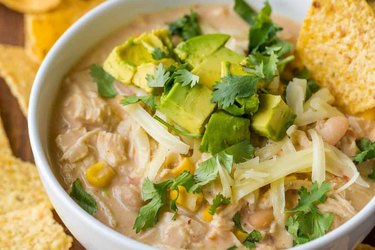 Easy Chicken Chili in white bowl with tortillas