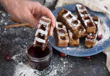 Gingerbread Waffle French Toast Sticks on a powder blue plate with powdered sugar and maple syrup