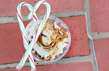 Gingerbread Breakfast Bowl on a red brick background with candy canes
