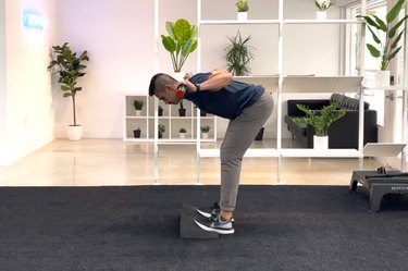 man doing toes elevated good morning exercise