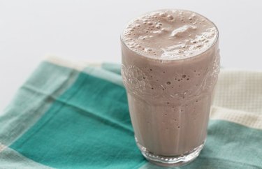 Vegan Chocolate Shake in a glass on top of a teal-colored cloth napkin