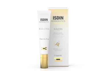 a photo of a tube of ISDIN K-Ox Eyes next to its box for saggy eyelid skin on a white background