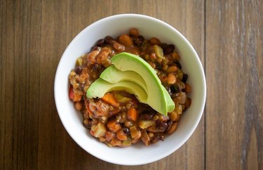 Slow Cooker Vegan Chili in a white bowl with avocado slices
