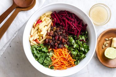 Everyday Detox Salad With Citrus Ginger Dressing on white bowl on marble countertop.