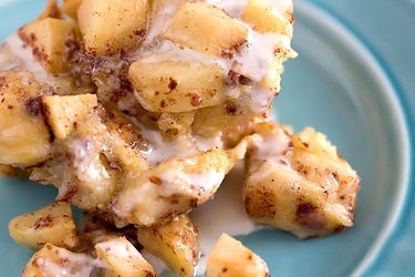 Crock-Pot apple cinnamon roll casserole on a blue plate