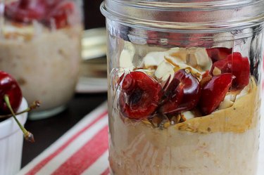 Slow cooker cherry almond steel-cut oats in a mason jar.