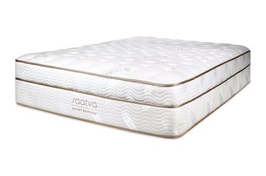 A white mattress with gold lining on a white background