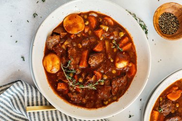 Classic Beef and Tomato Stew in white bowls on marble table