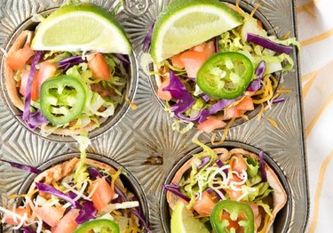 High Protein Muffin Tin Dinner Muffin Tin Mexican Bowls with jalapeno slices and lime wedges