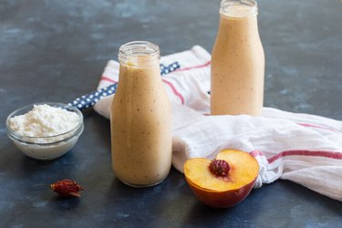 Peaches and cream protein shake, a high-protein breakfast, in a jar next to cottage cheese