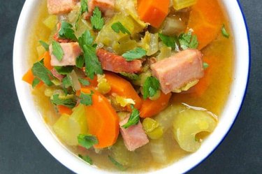 Slow Cooker Split Pea Soup in a white bowl on table.