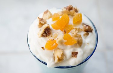 Trail Mix Almond Yogurt Parfait in a glass against a white background