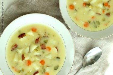 Two bowls of Dill Pickle Soup next to a spoon