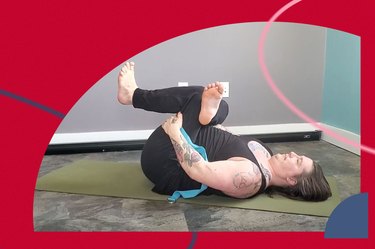 Person does the figure 4 stretch for mobility on a yoga mat in a home gym