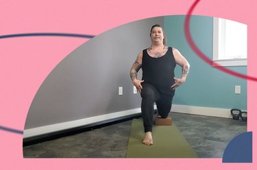 Person in a black body suit does the half-kneeling lunge with their back knee on a yoga block for mobility on a yoga mat in a home gym
