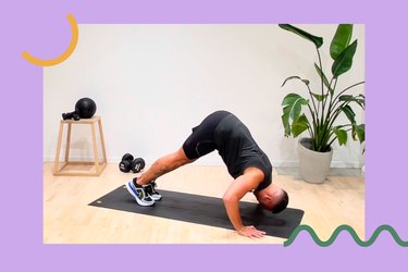 a trainer does a pike push-up on a black yoga mat in front of a plant to demonstrate one of the hardest arm exercises with a purple background